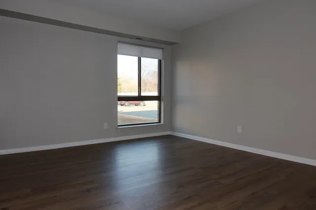 a view of a street with cars on both side of the road