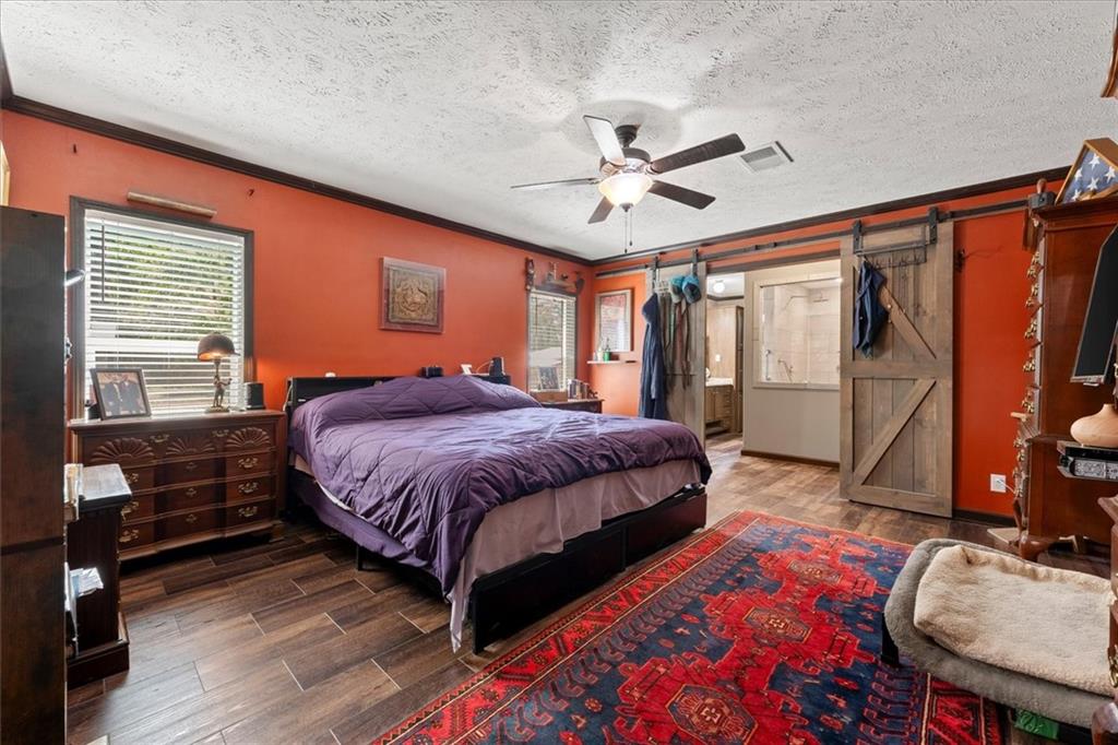 170 Anoia Road Washington, GA 30673 - Photo 13 of 46 a bedroom with a bed and wooden floor