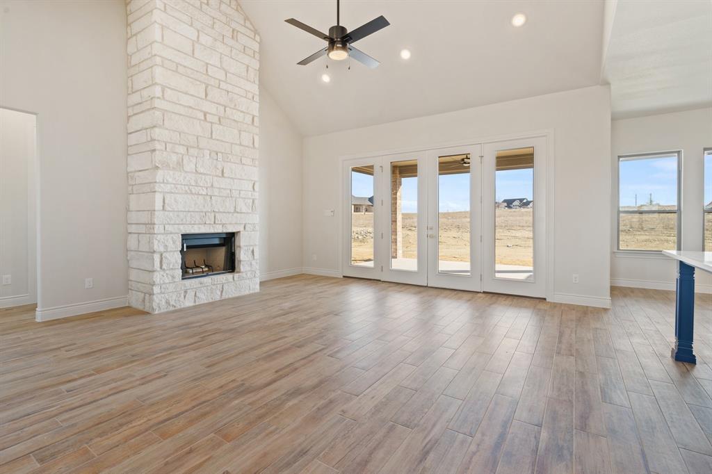412 Collum View Azle, TX 76020 - Photo 6 of 37 Beautiful stone to ceiling fireplace with a wood beam across the top.