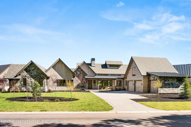 a view of house with garden and swimming pool