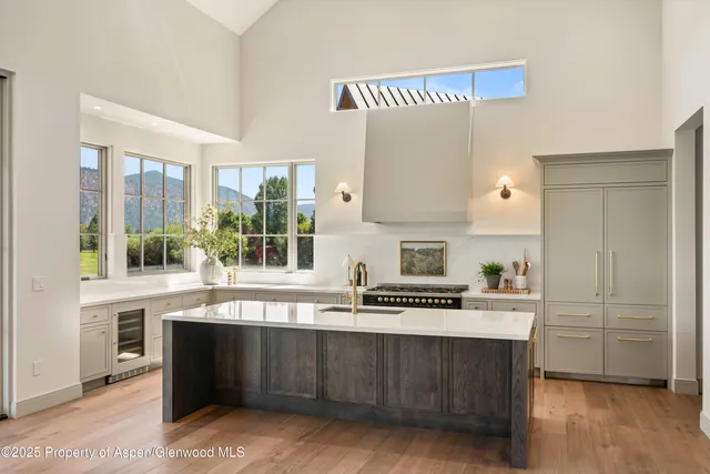 a kitchen with stainless steel appliances a sink stove and cabinets