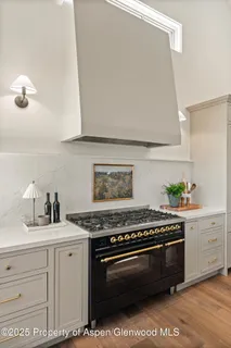 a view of a livingroom with wooden floor a fireplace and window