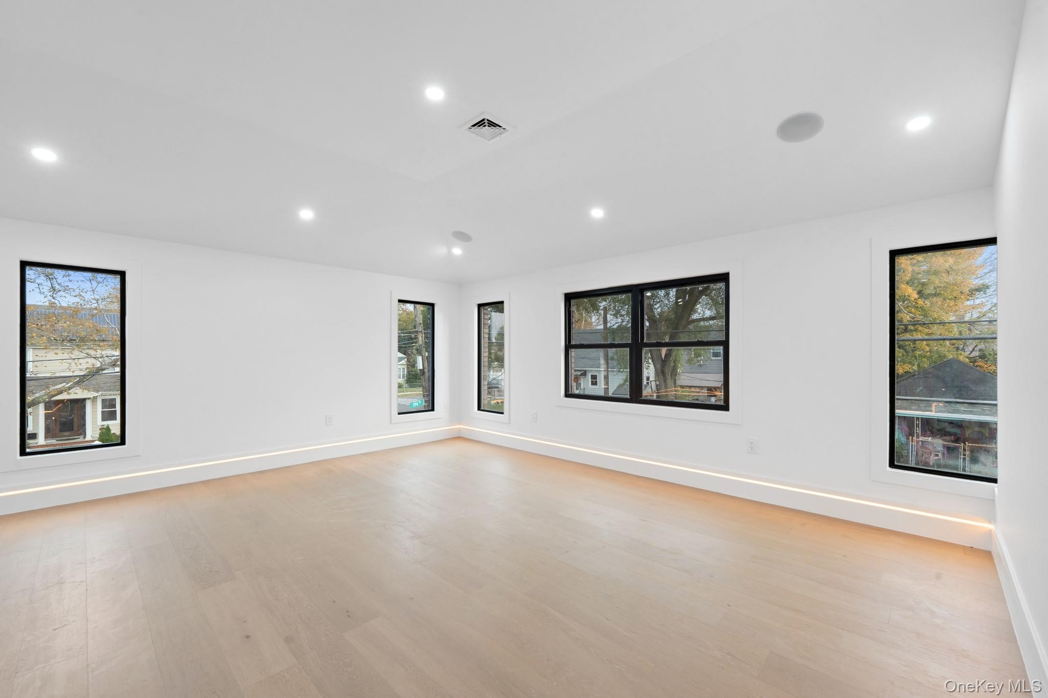 116-20 194th Street Queens, NY 11412 - Photo 17 of 27 Empty room with recessed lighting, plenty of natural light, and light wood-type flooring