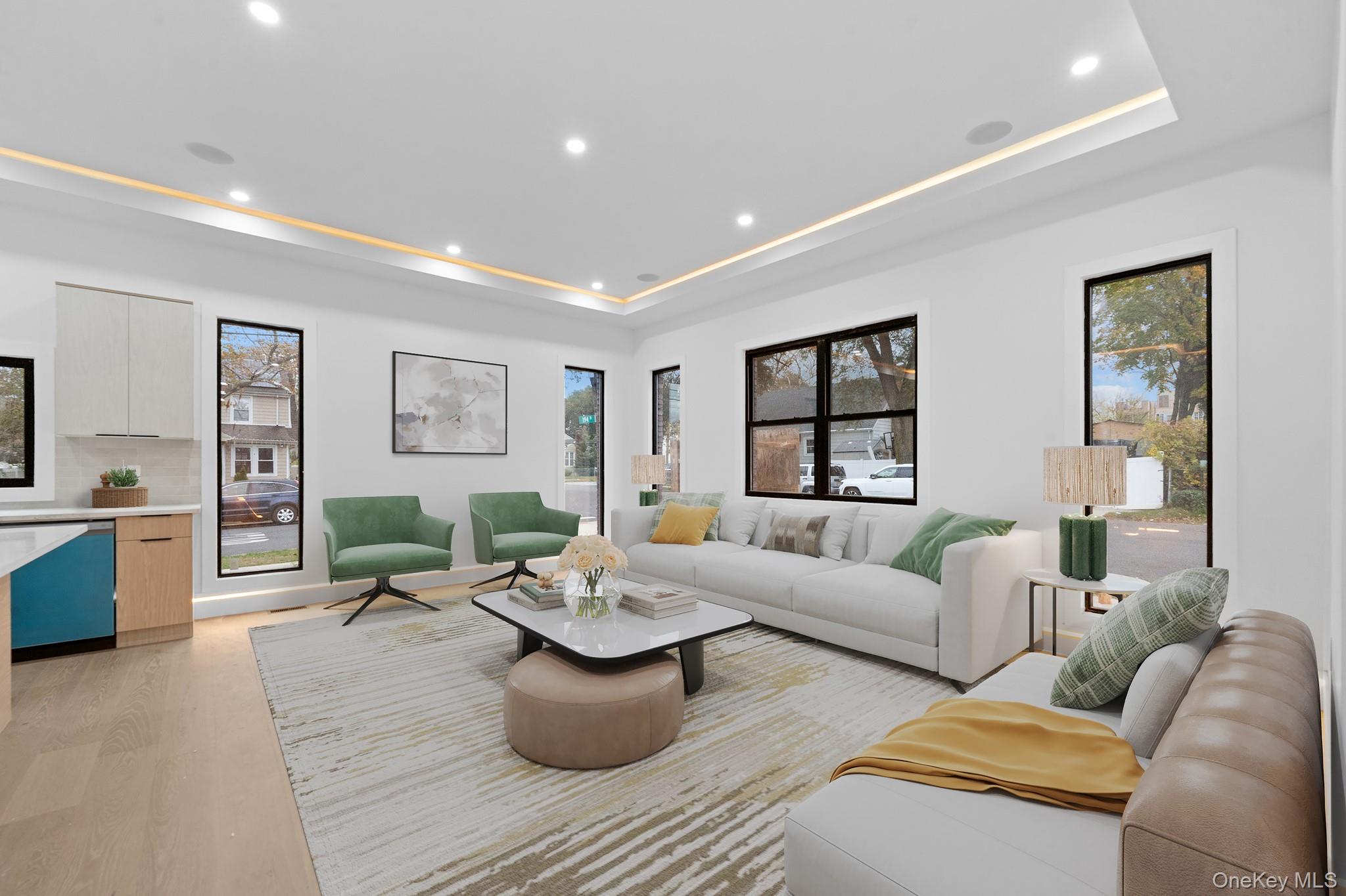 116-20 194th Street Queens, NY 11412 - Photo 2 of 27 Living room featuring a raised ceiling, recessed lighting, and light wood-style flooring
