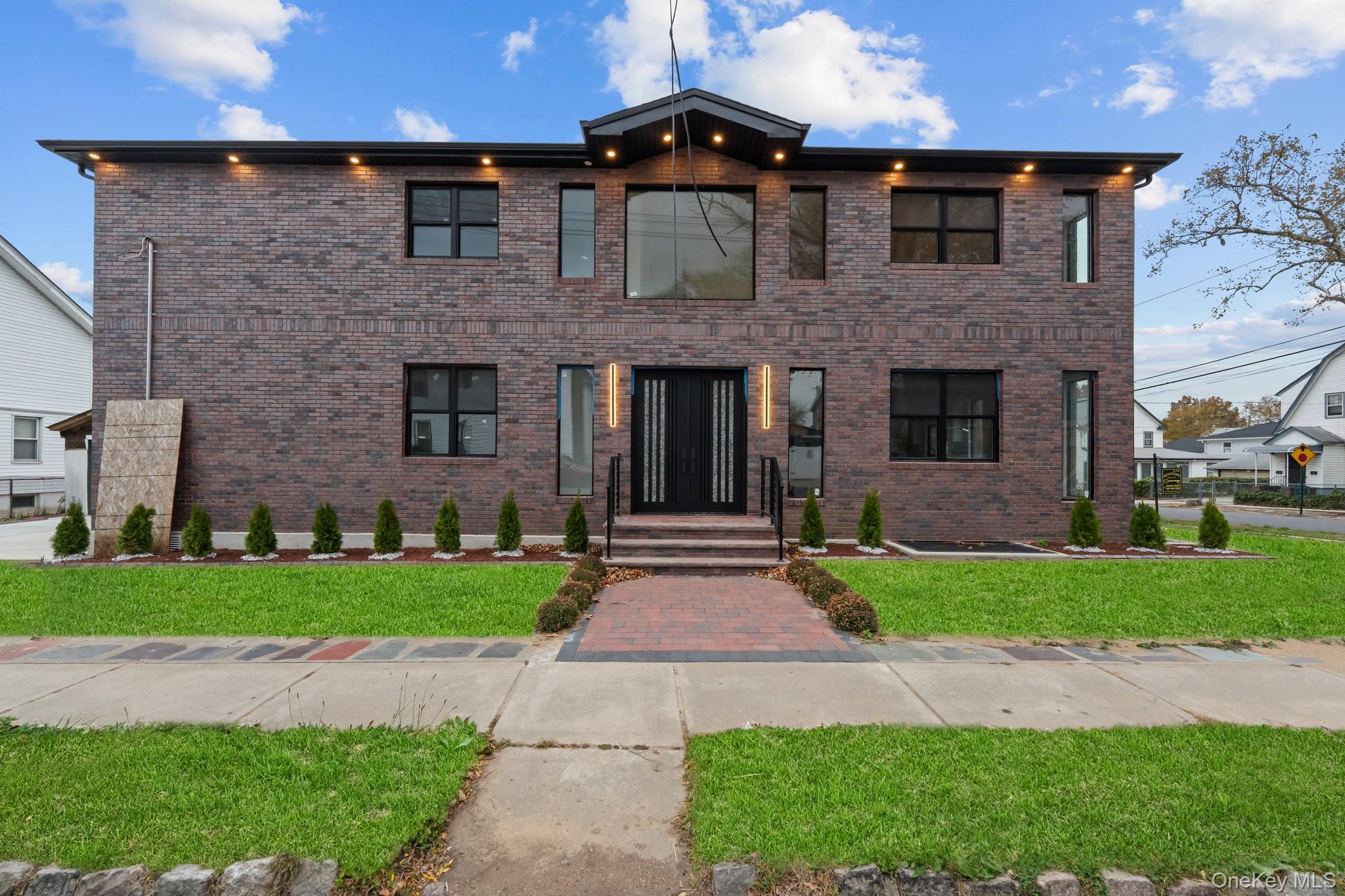 116-20 194th Street Queens, NY 11412 - Photo 27 of 27 View of front of property featuring brick siding and a front lawn