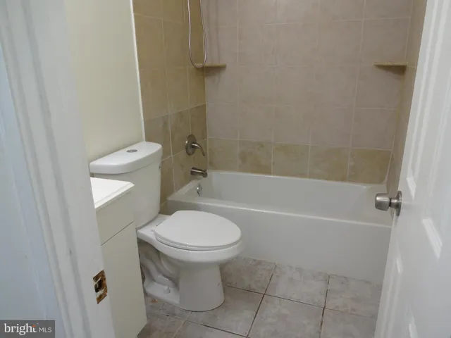 a bathroom with a sink a toilet and bathtub