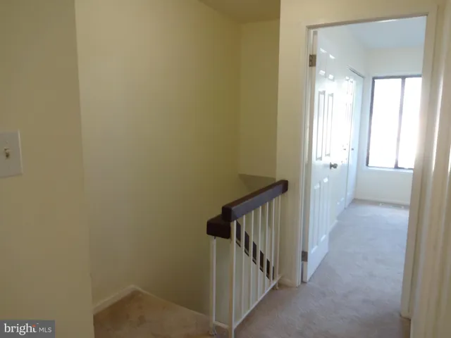 a view of a hallway with white walls