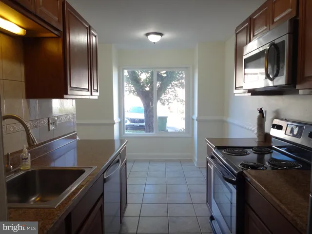 a kitchen that has a sink and a stove
