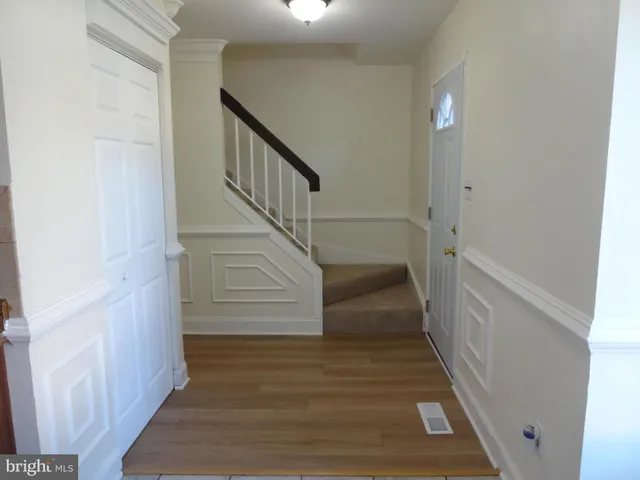 a view of entryway and gallery with wooden floor