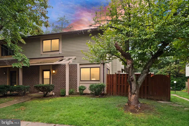 a front view of a house with a garden and yard