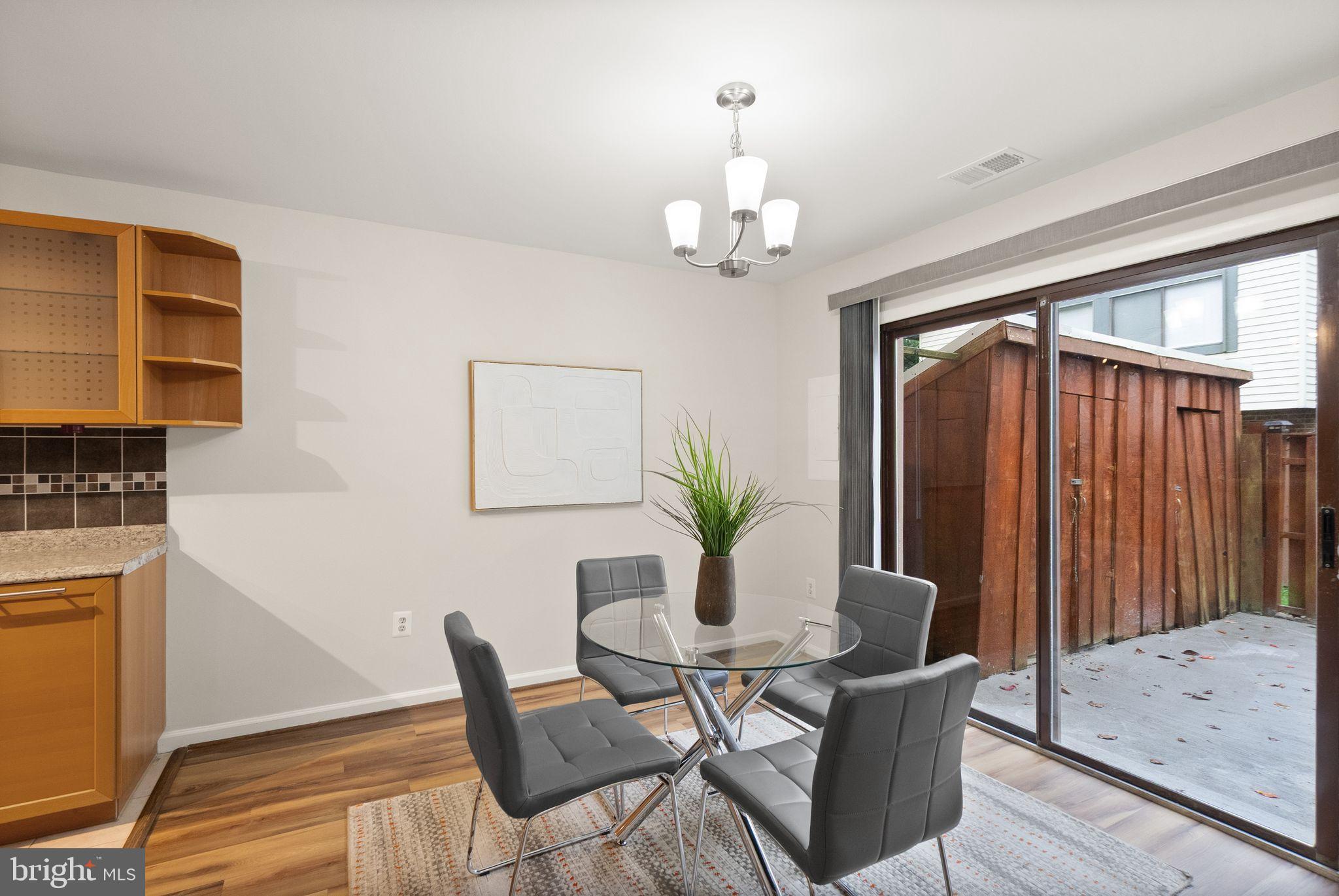 10679 Spring Oak Court Burke, VA 22015 - Photo 14 of 42 a view of a dining room with furniture and wooden floor