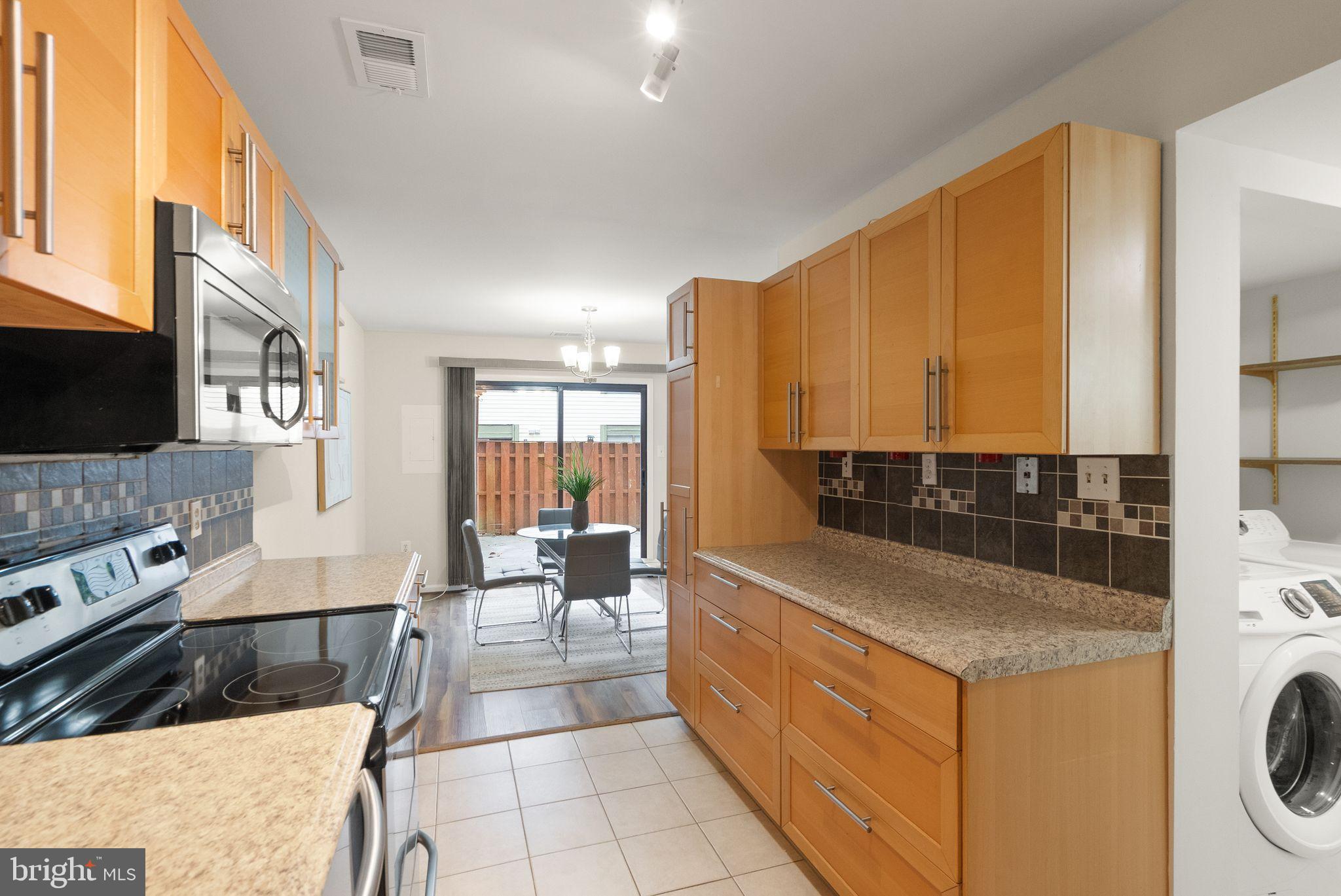 10679 Spring Oak Court Burke, VA 22015 - Photo 15 of 42 a large white kitchen with a large window