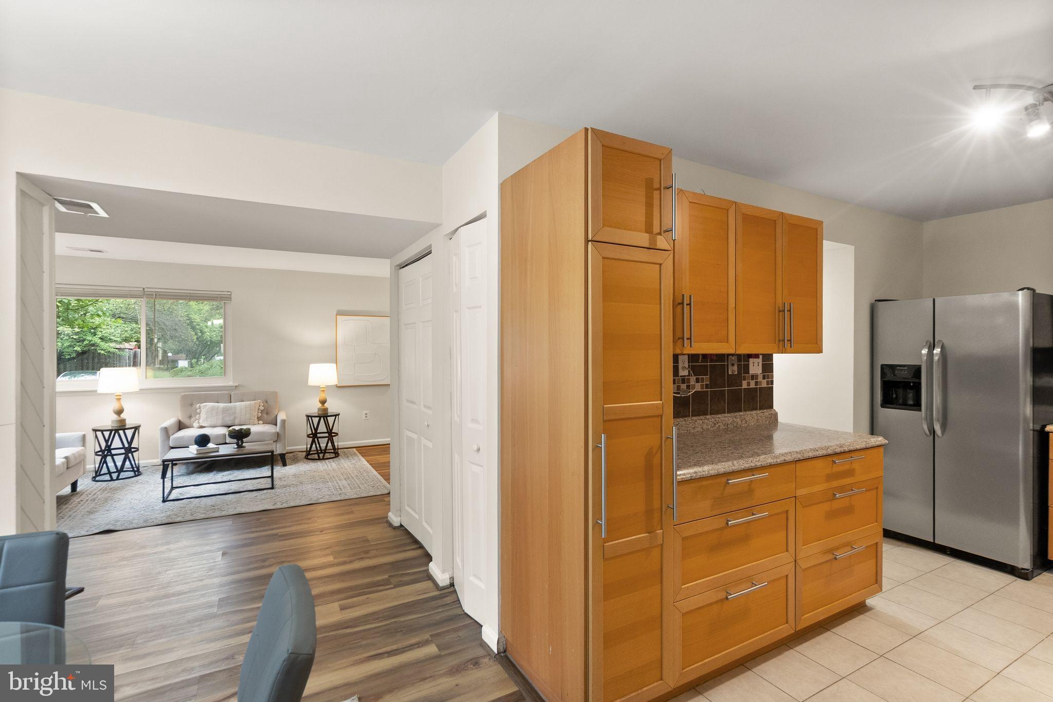 10679 Spring Oak Court Burke, VA 22015 - Photo 19 of 42 a kitchen with sink cabinets and refrigerator