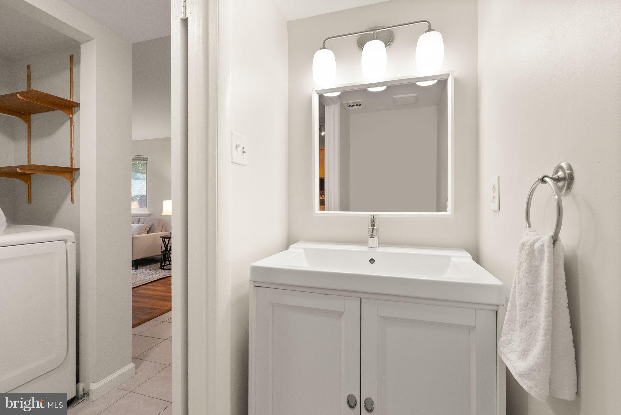 10679 Spring Oak Court Burke, VA 22015 - Photo 21 of 42 a bathroom with a sink a mirror and a toilet