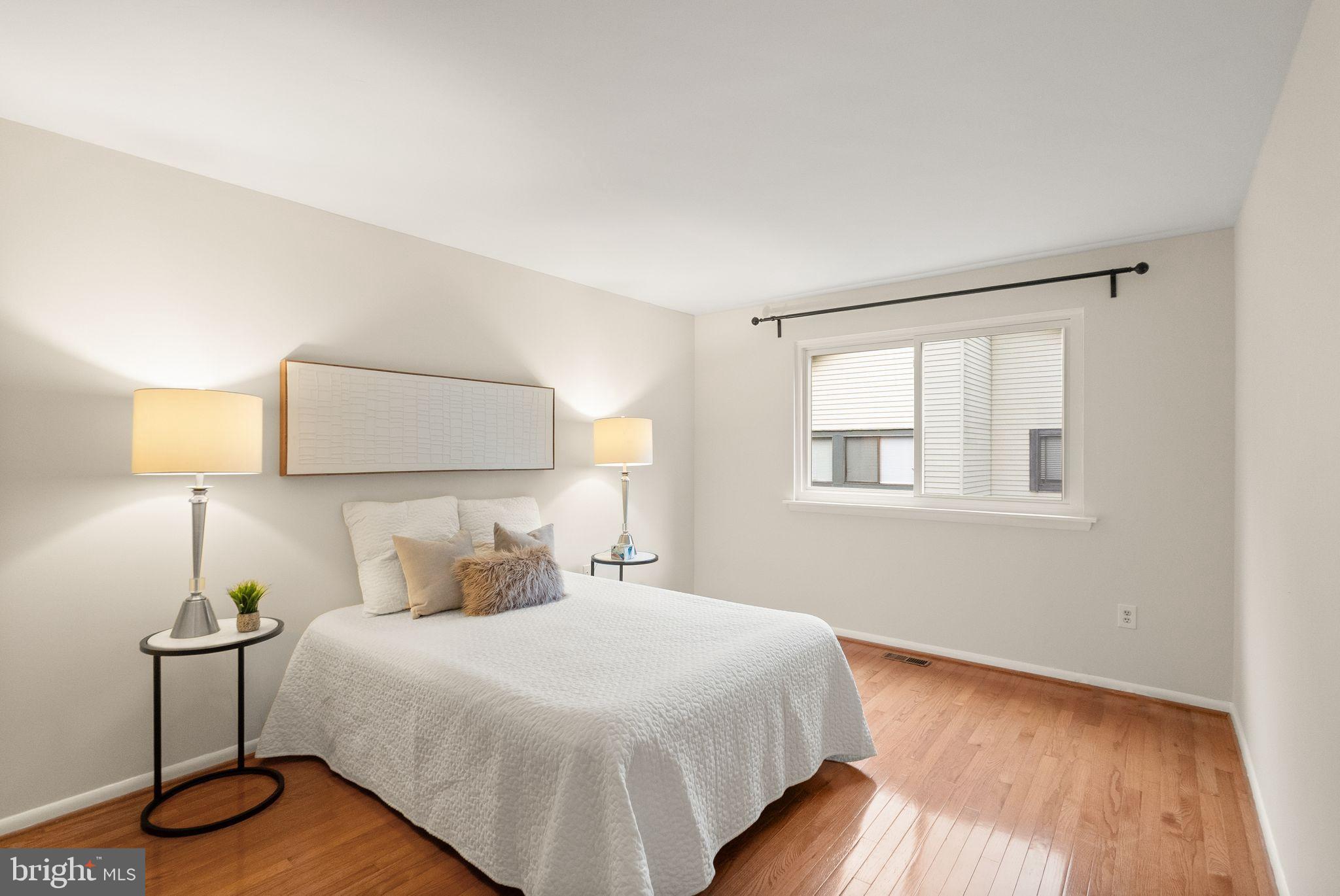 10679 Spring Oak Court Burke, VA 22015 - Photo 24 of 42 a bedroom with a bed and a night stand