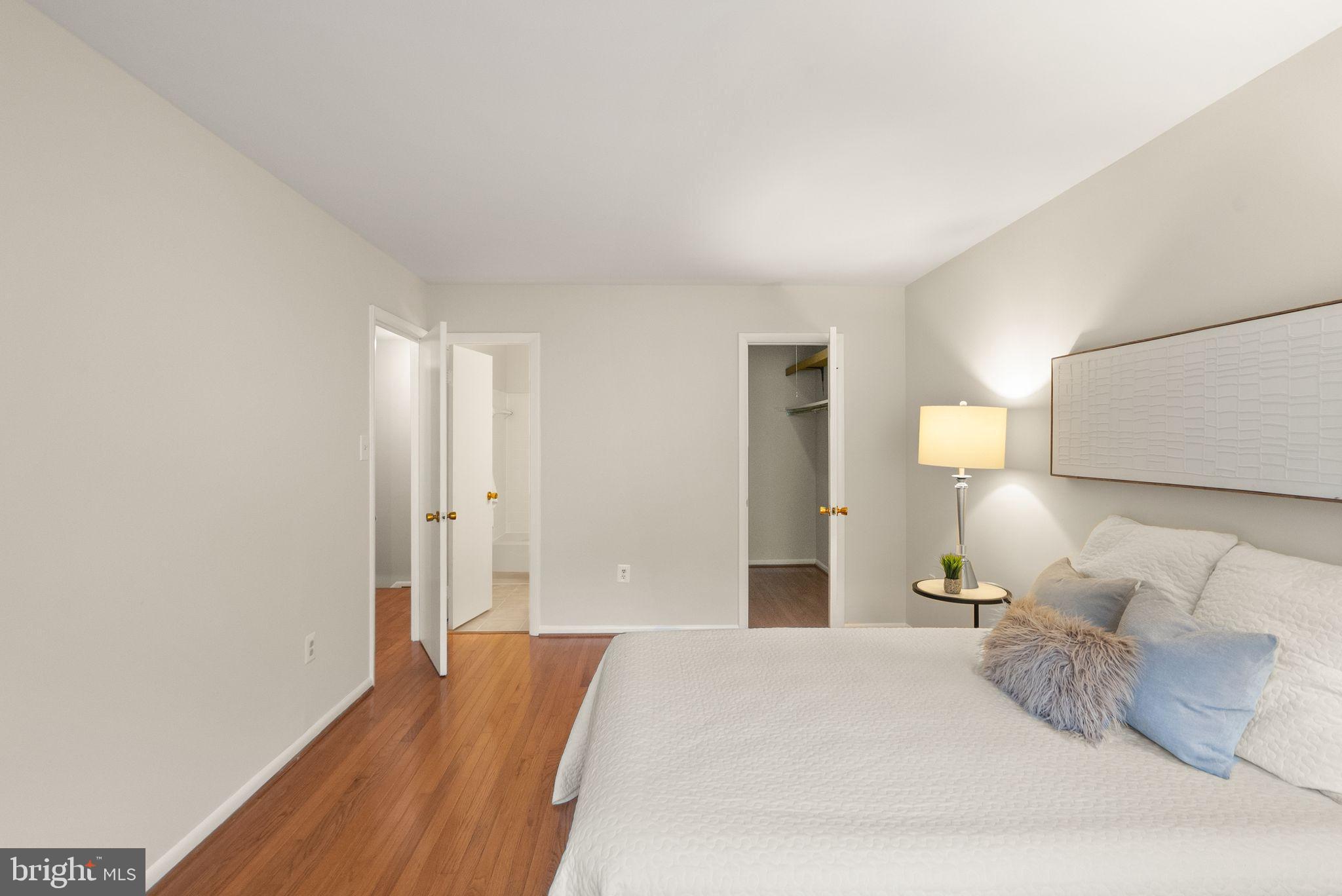 10679 Spring Oak Court Burke, VA 22015 - Photo 25 of 42 a bedroom with a bed and a lamp
