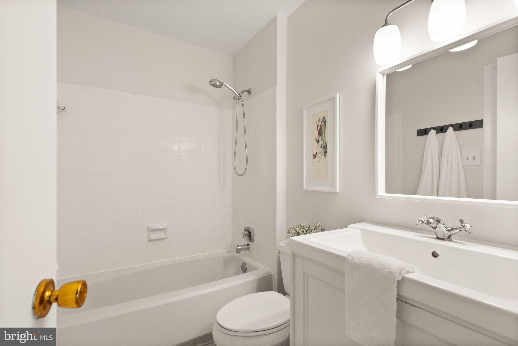 10679 Spring Oak Court Burke, VA 22015 - Photo 28 of 42 a bathroom with a sink a toilet and shower