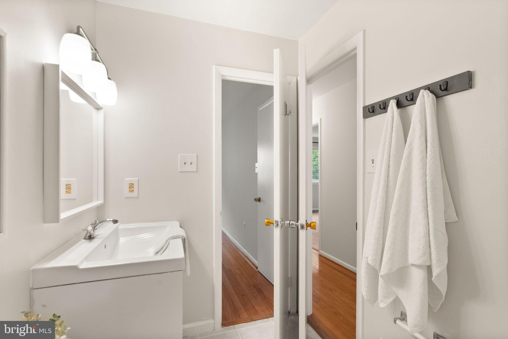 10679 Spring Oak Court Burke, VA 22015 - Photo 29 of 42 a bathroom with a sink toilet and shower