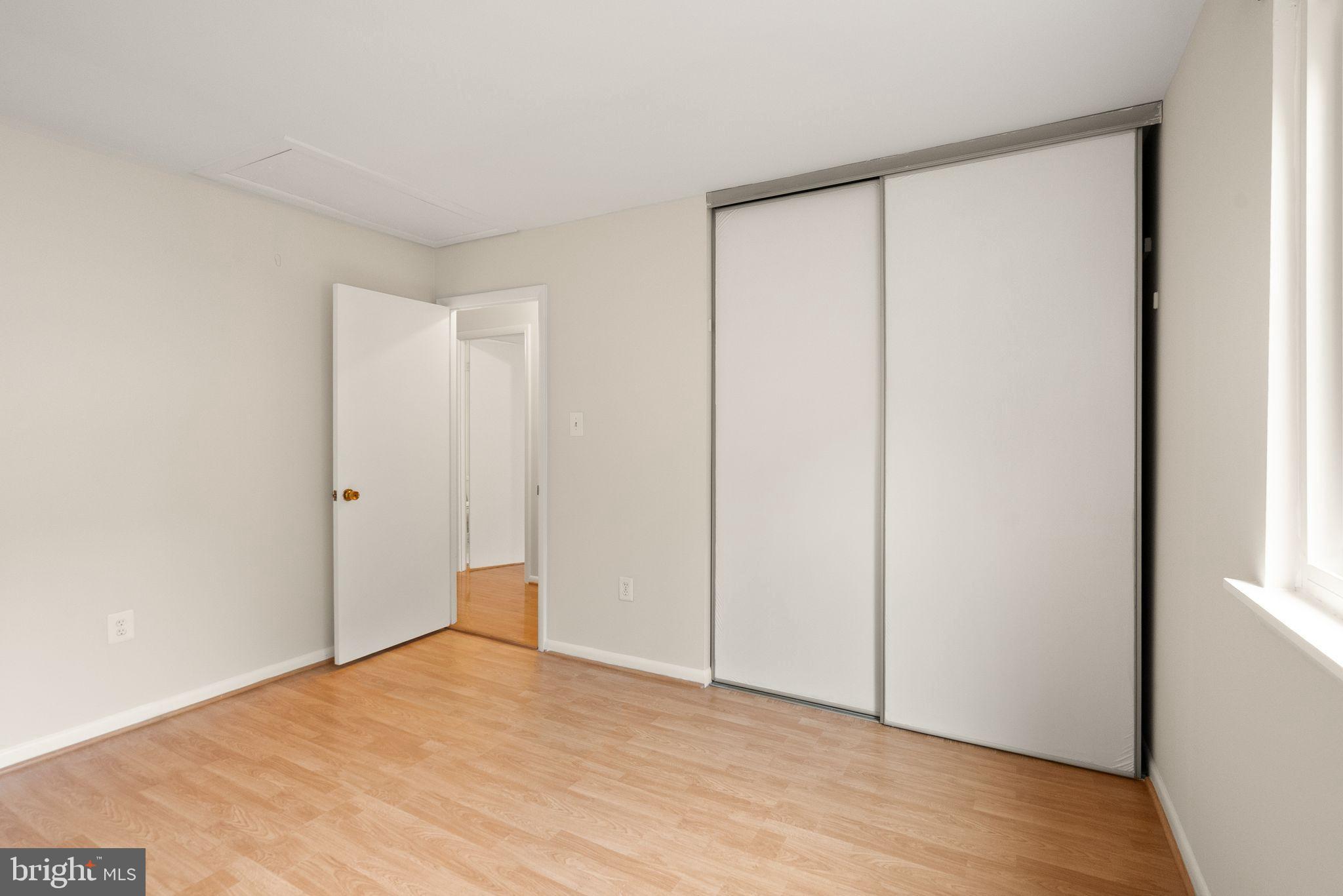 10679 Spring Oak Court Burke, VA 22015 - Photo 32 of 42 a view of an empty room with wooden floor and a window
