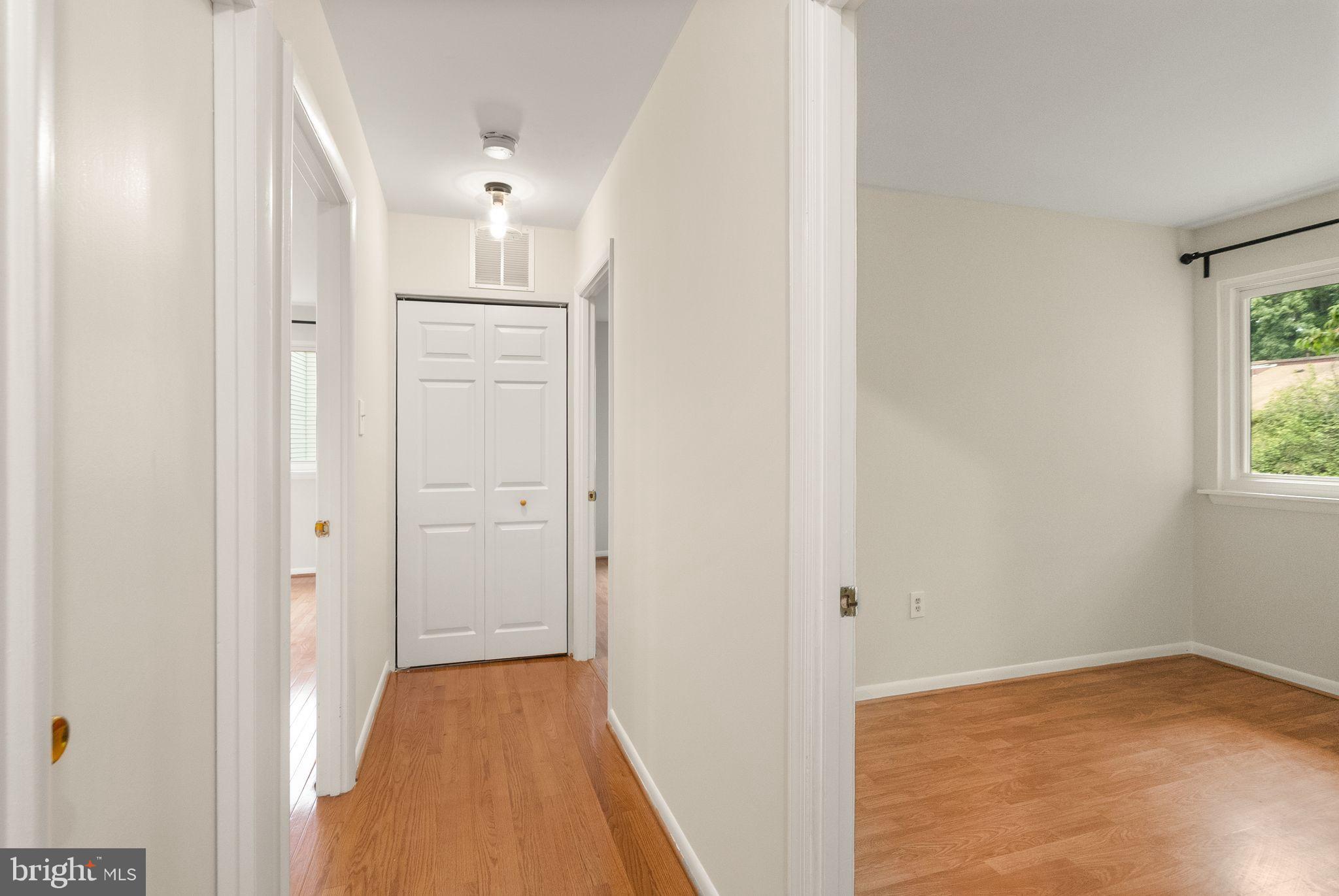 10679 Spring Oak Court Burke, VA 22015 - Photo 33 of 42 a view of a hallway with wooden floor and a window
