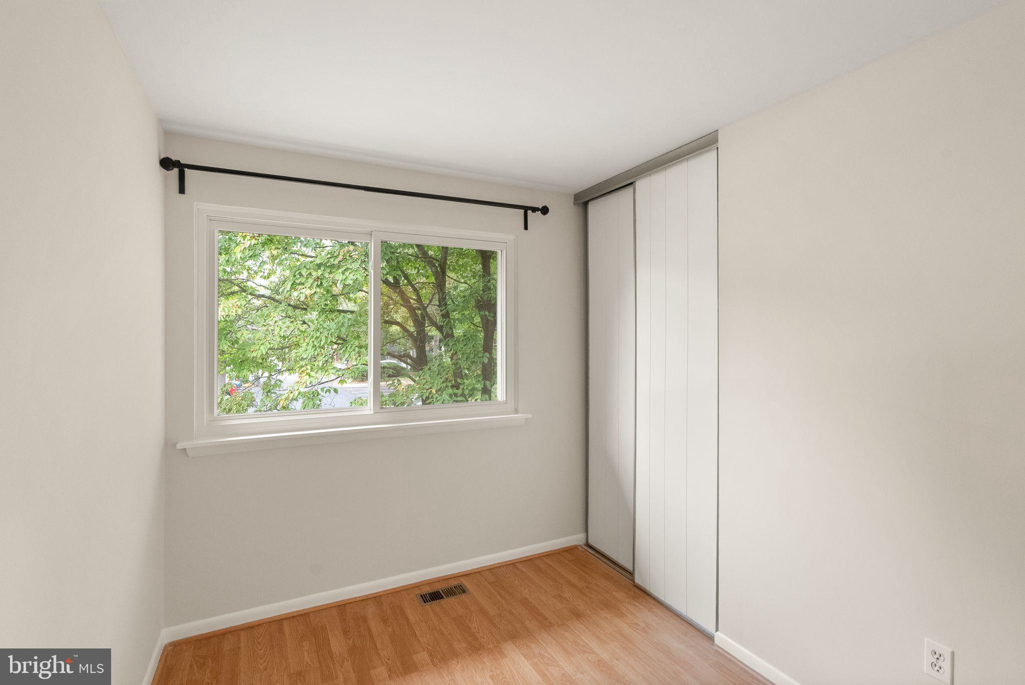 10679 Spring Oak Court Burke, VA 22015 - Photo 35 of 42 a view of an empty room with wooden floor and a window