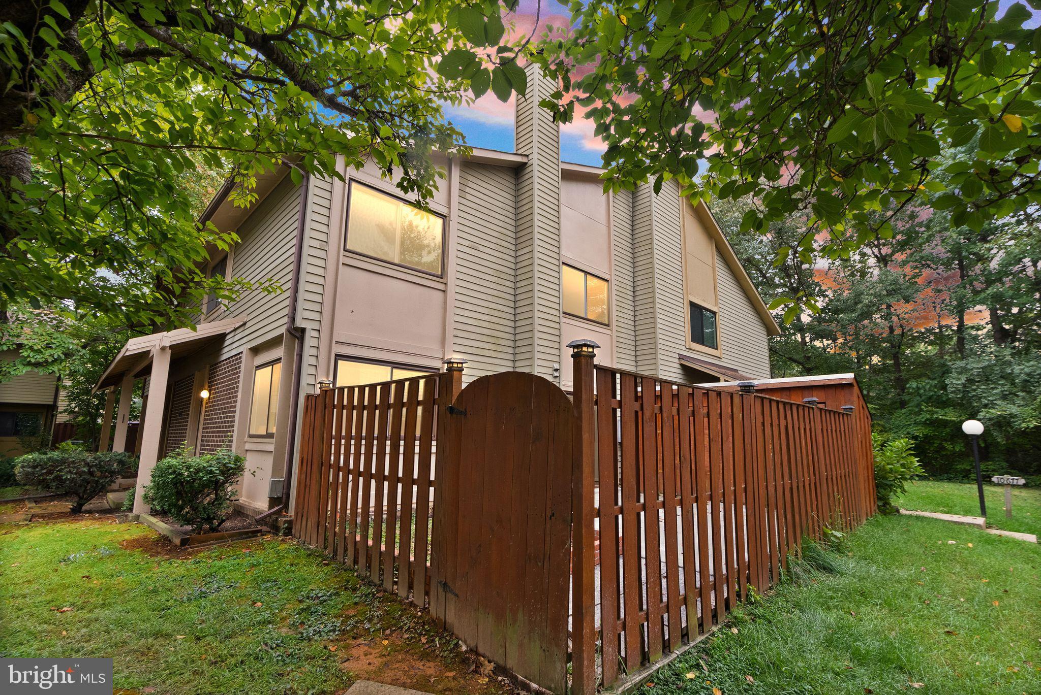 10679 Spring Oak Court Burke, VA 22015 - Photo 38 of 42 a view of a house with a small yard and a large tree