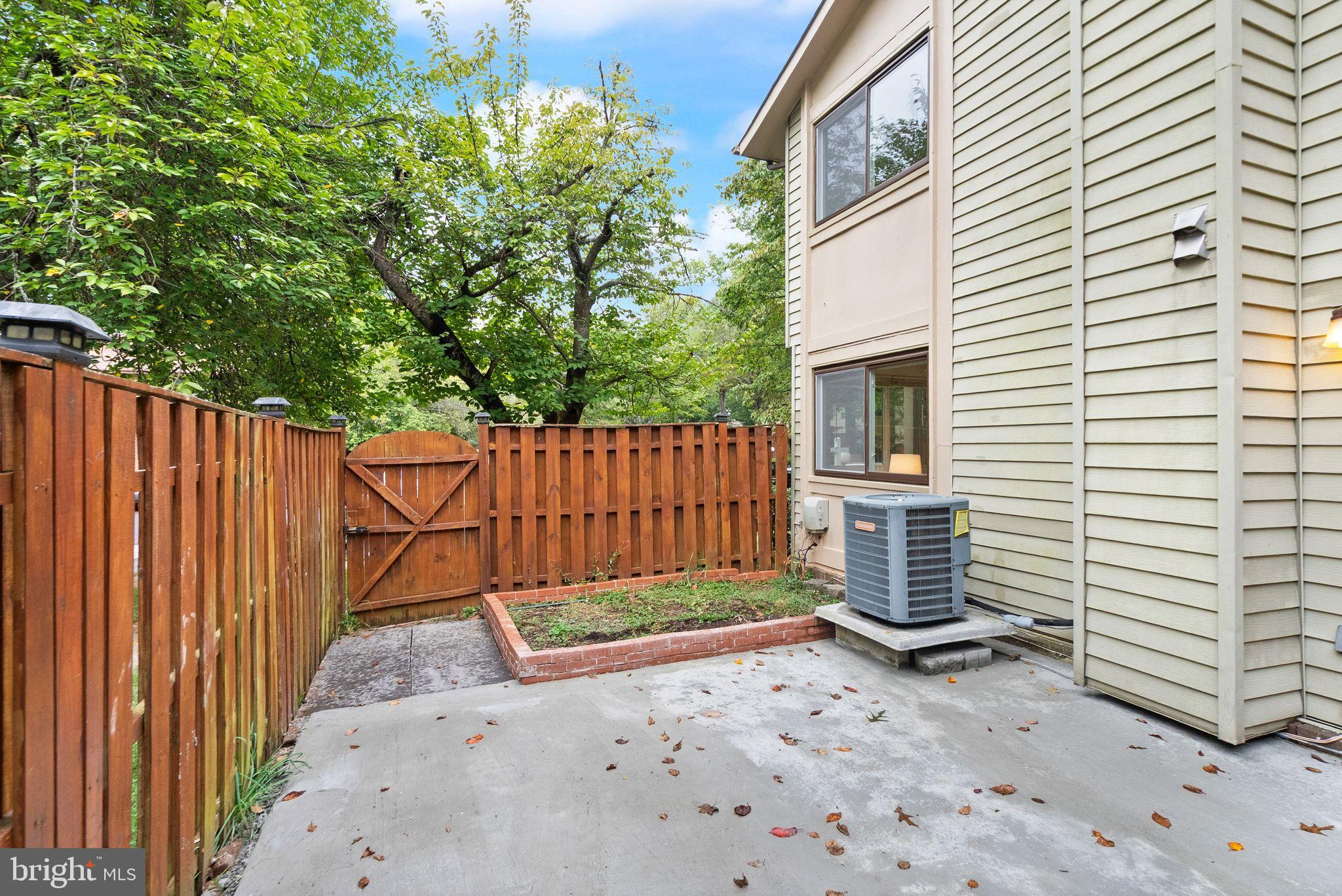 10679 Spring Oak Court Burke, VA 22015 - Photo 39 of 42 a view of a backyard with a fence and trees