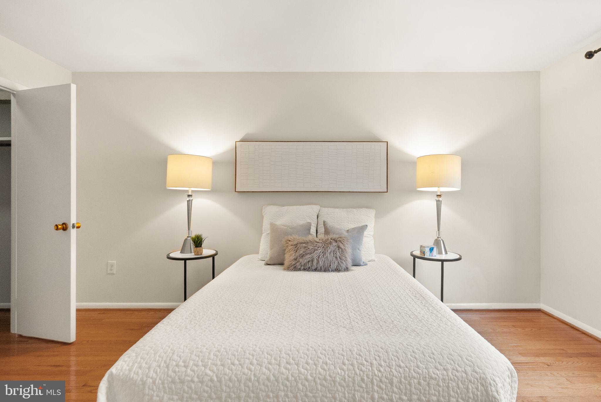 10679 Spring Oak Court Burke, VA 22015 - Photo 6 of 42 a bedroom with a bed and a night stand
