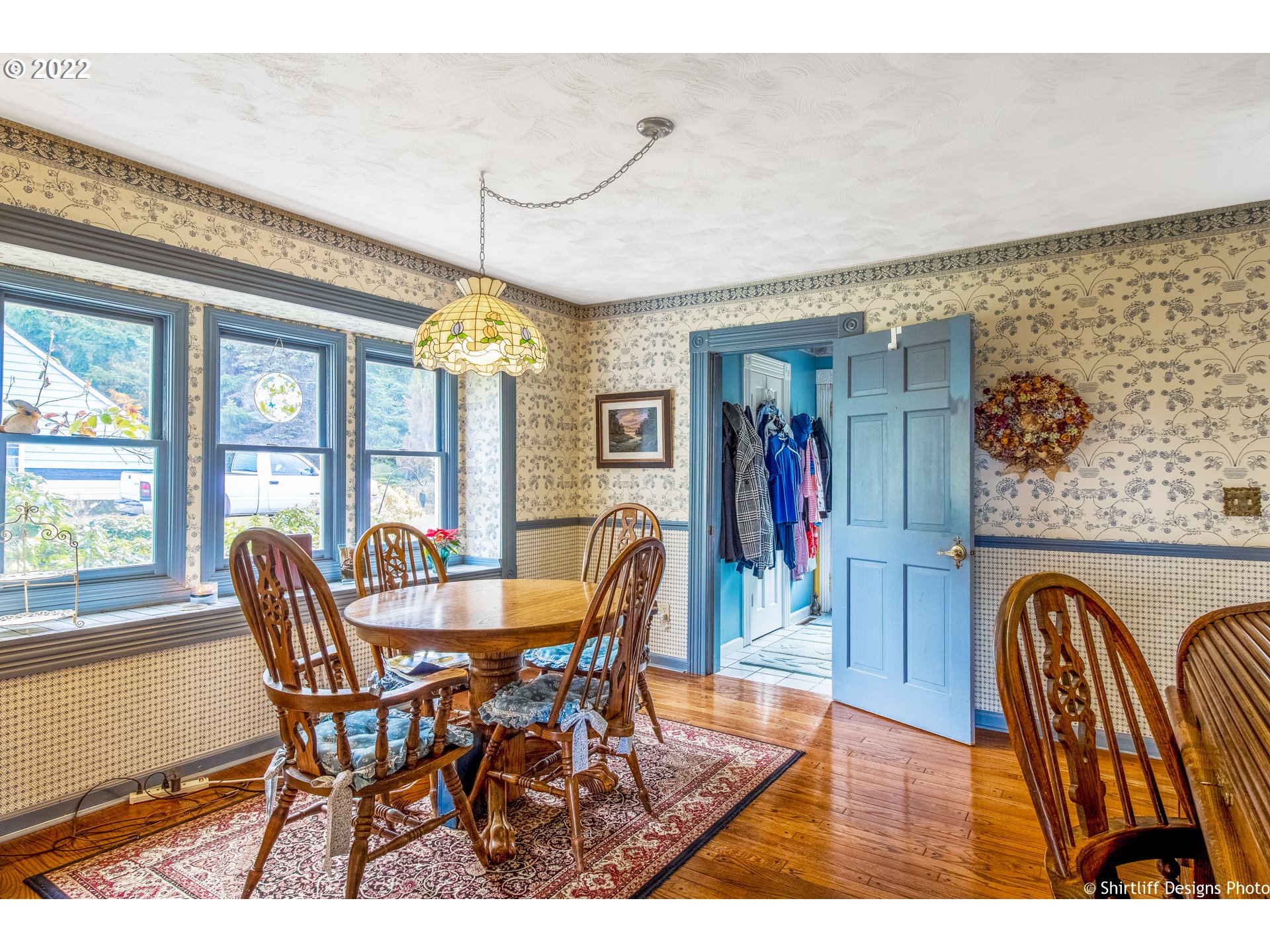 32482 Doolittle Road Cottage Grove, OR 97424 - Photo 11 of 32 a dining room with furniture wooden floor a rug and a painting