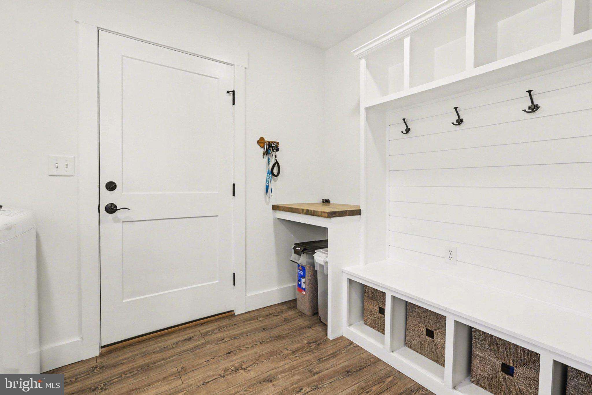 545 Pleasant View Road Lewisberry, PA 17339 - Photo 26 of 62 a hallway with white cabinets and wooden floor