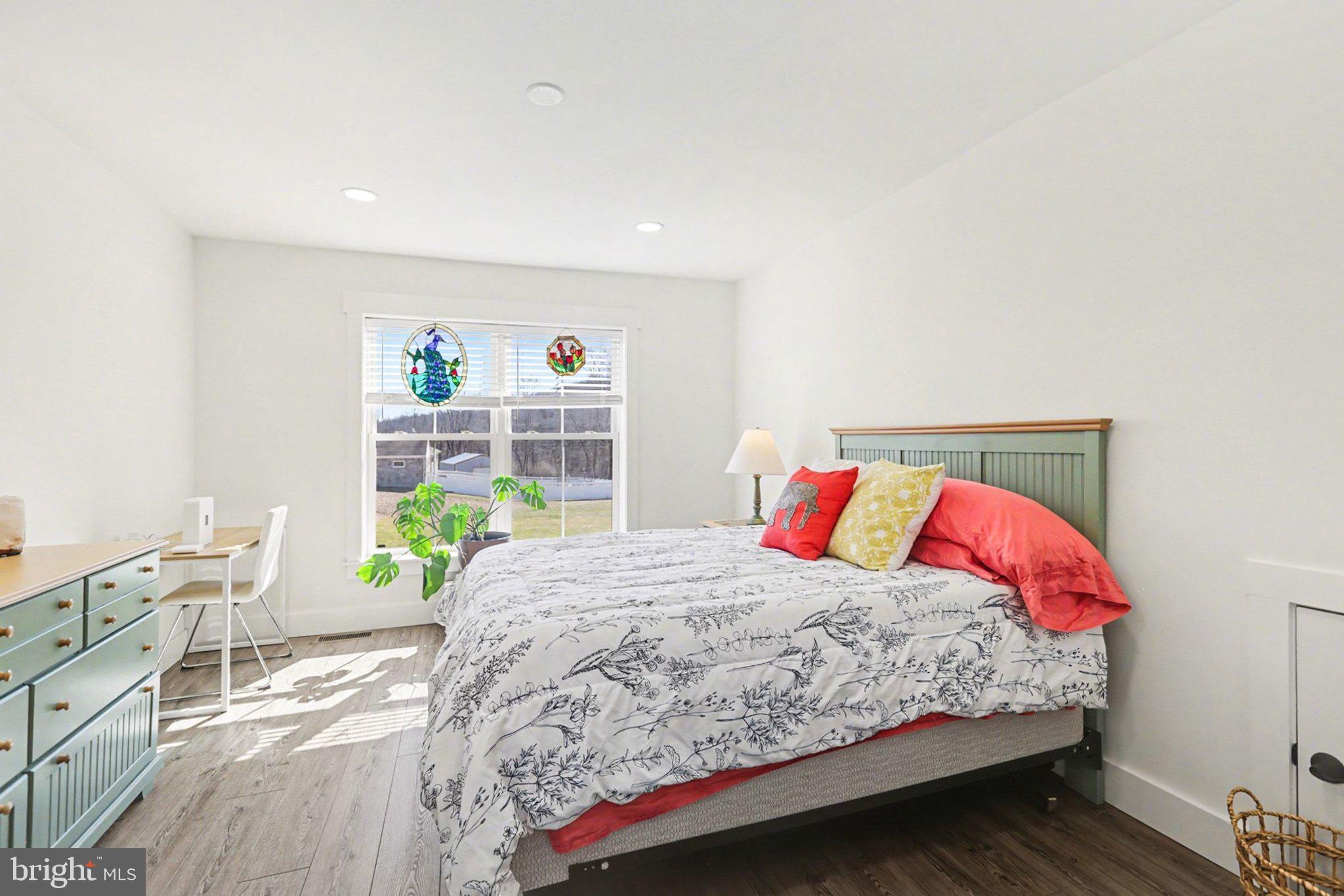 545 Pleasant View Road Lewisberry, PA 17339 - Photo 28 of 62 a bedroom with a bed and a wooden floor