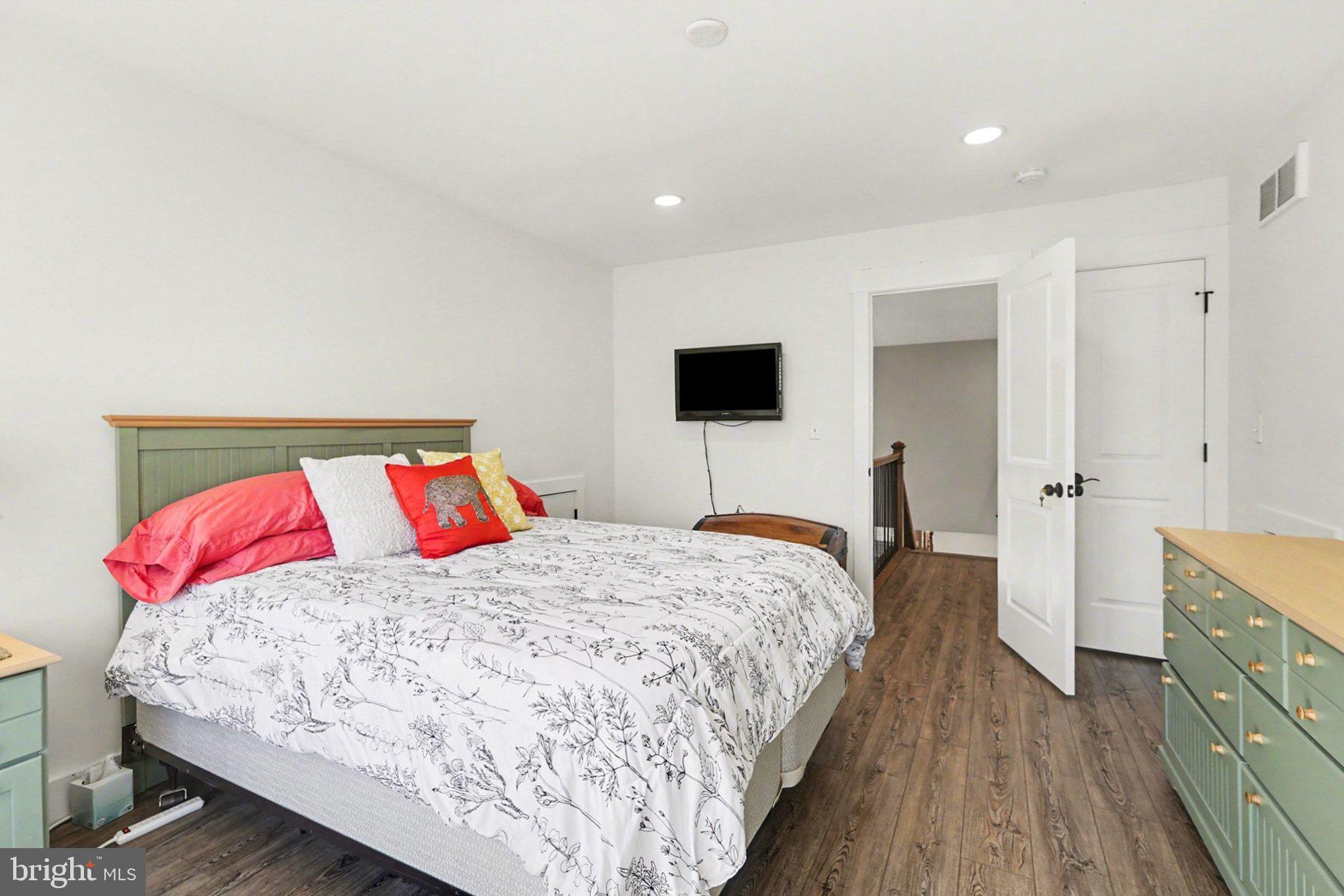 545 Pleasant View Road Lewisberry, PA 17339 - Photo 30 of 62 a bedroom with a bed and a flat tv screen on dresser