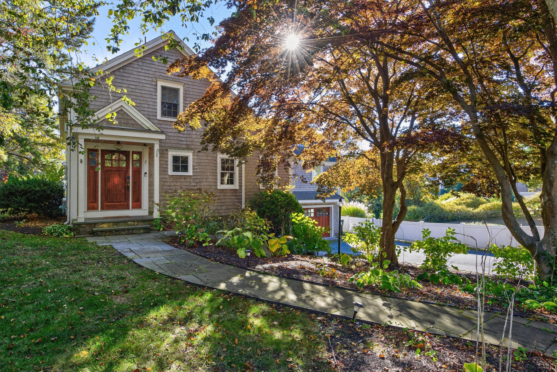 a front view of house with yard and green space