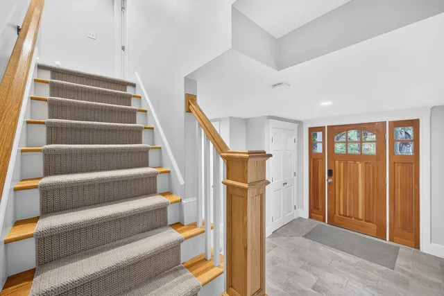 a view of staircase with white walls and a window