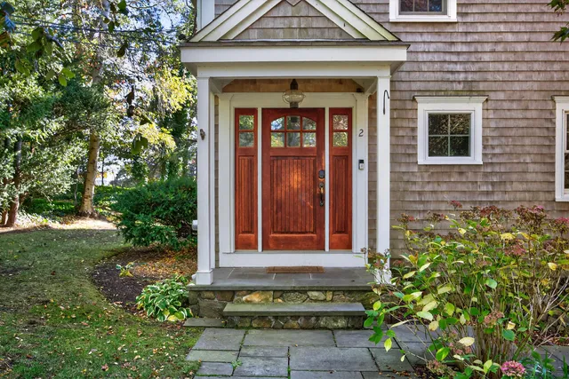 a front view of a house with a garden