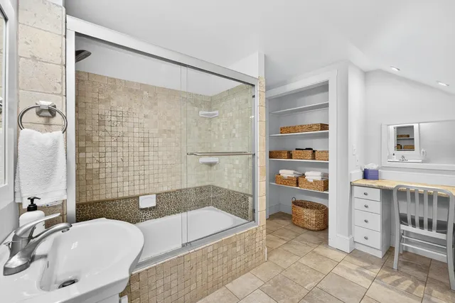 a bathroom with a granite countertop bathtub shower sink and toilet