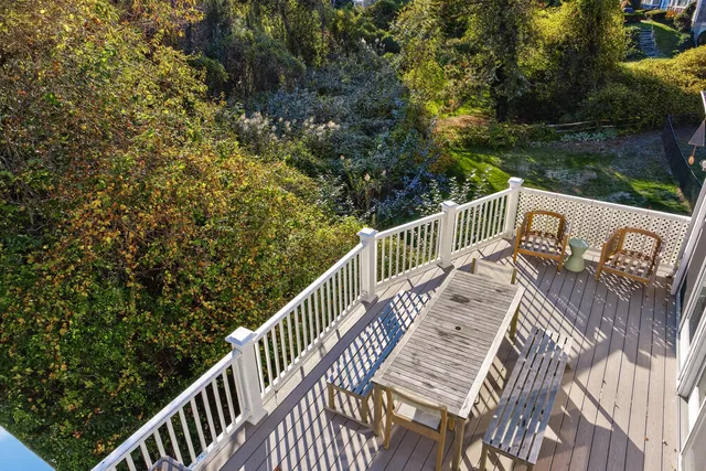 a view of a balcony with wooden floor