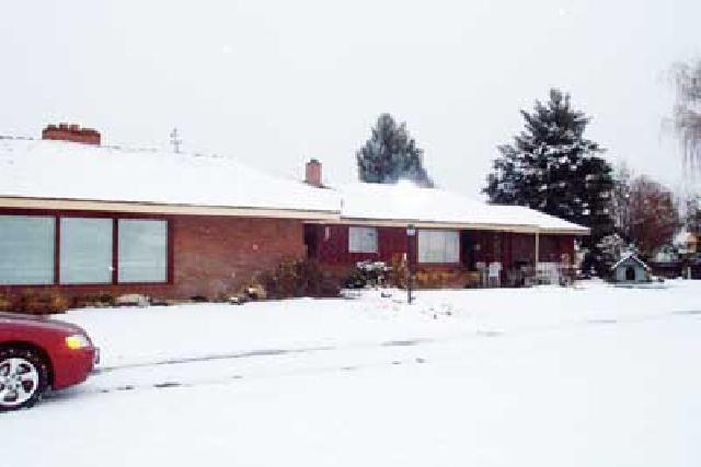 2102 Ahtanum Road Yakima, WA 98903 - Photo 1 of 3 a front view of a house with a yard covered in snow