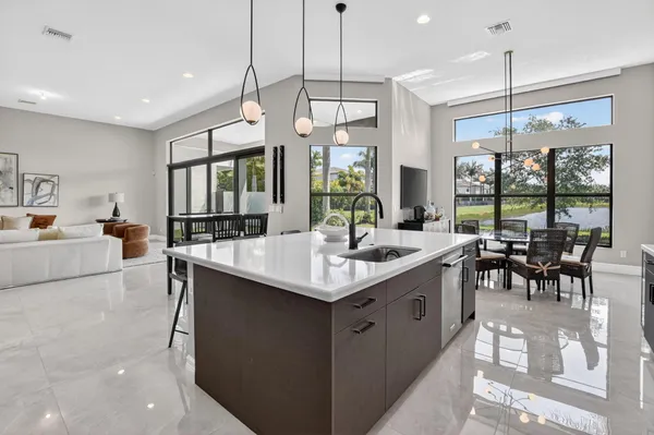 a kitchen with stainless steel appliances a sink dishwasher stove and cabinets
