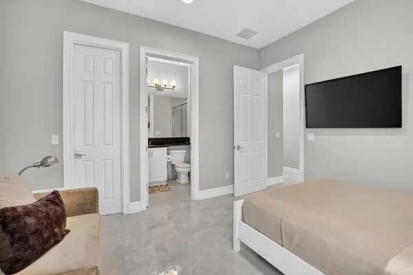 a bedroom with a bed and couch