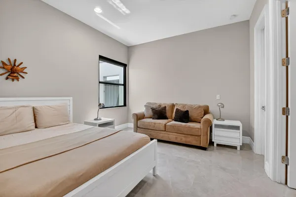 a spacious bedroom with a bed and a large window