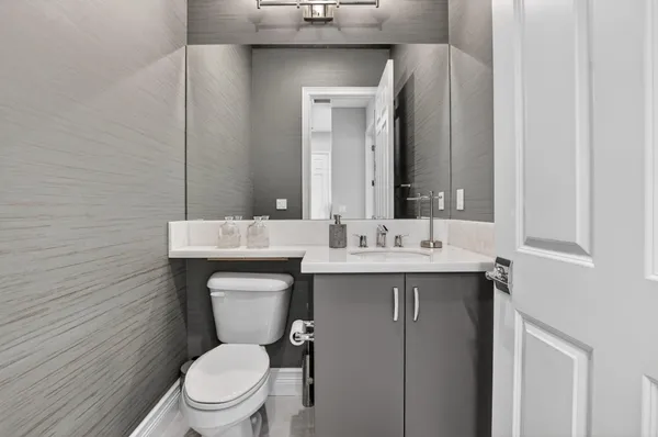 a bathroom with a sink tub double vanity and a window