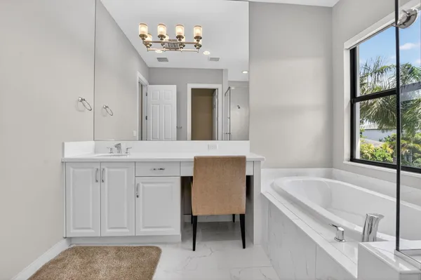a bathroom with a granite countertop sink a toilet and a mirror