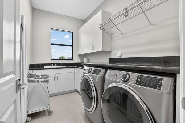 a view of a house with a swimming pool and outdoor seating