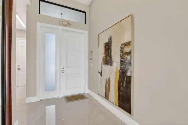 a view of a hallway with dining area and glass door