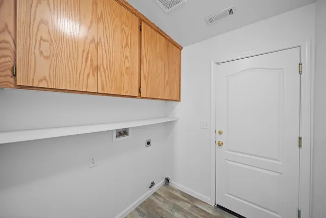 a view of storage and utility room with closet