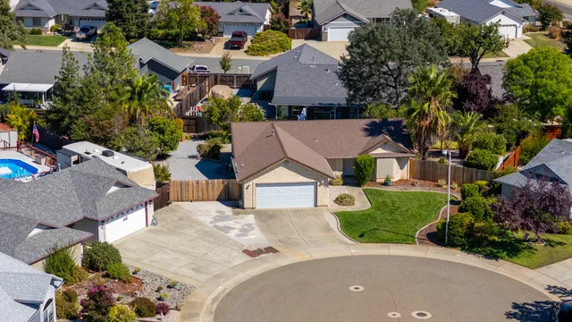 an aerial view of a house with a yard and garden