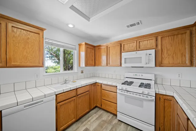 a kitchen with a sink stove and cabinets