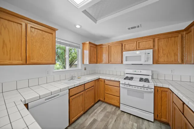 a kitchen with a sink stove and cabinets