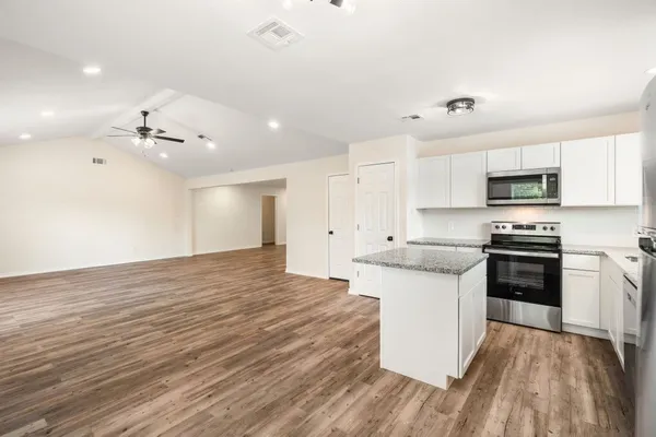a kitchen with stainless steel appliances a sink dishwasher stove refrigerator and microwave